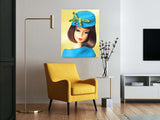 Fashion Editor Barbie paintng by artist Judy Ragagli hanging above a yellow chair.